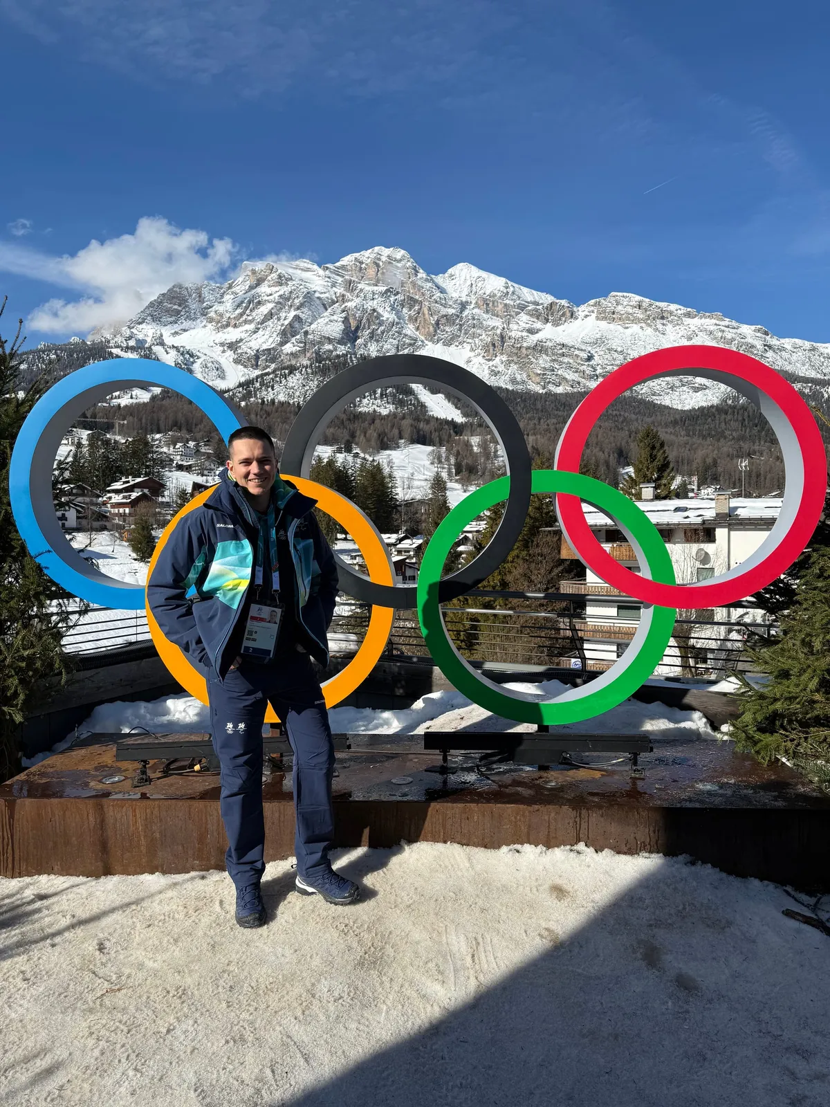 Me at the Olympic Games in Cortina, with the Olympic rings behind me and the beautiful Dolomites